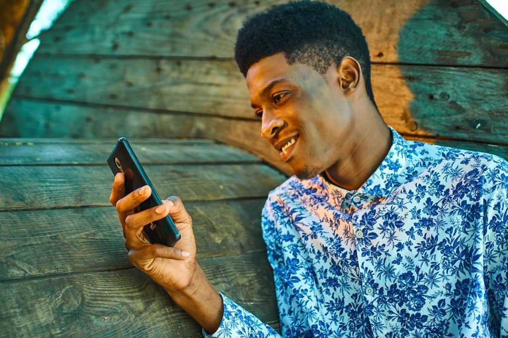 Kenyan Man using mobile phone